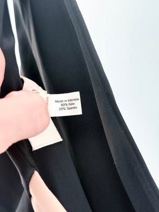 Camila Coelho modern, color-block two-piece featuring an asymmetrical, one-shoulder style with a bold cutout detail across the front and the bottoms are high-cut with a slightly cheeky silhouette, S/M
