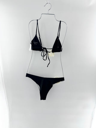 Lovers and Friends sleek, feminine two-piece with statement floral accents. Top is a minimal triangle style with thin adjustable straps and large rosette applique and bottoms are matching high-cut style with rosette at the hip, S/M