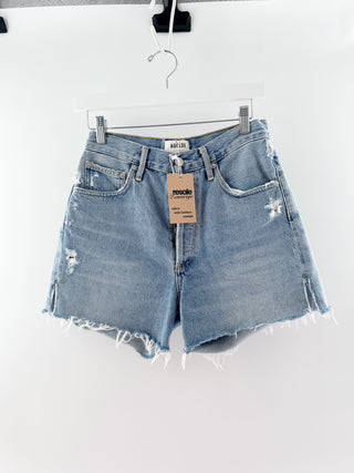 Agolde denim shorts featuring a high-rise waist with a button-fly closure, classic five-pocket styling and distressed detailing, finished with a raw frayed hem, 26