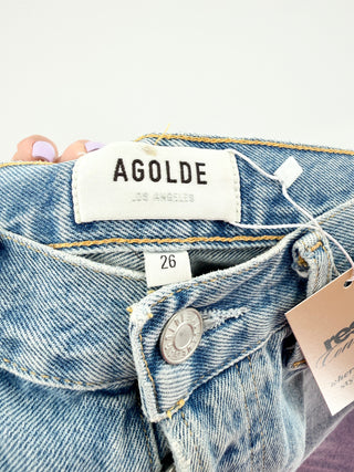 Agolde denim shorts featuring a high-rise waist with a button-fly closure, classic five-pocket styling and distressed detailing, finished with a raw frayed hem, 26