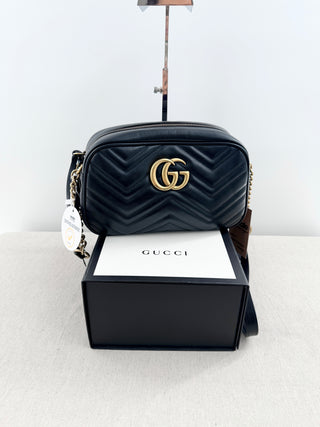 Gucci GG marmont camera bag in matelasse chevron leather with antique gold hardware and chain strap detailing