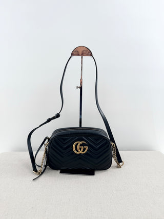 Gucci GG marmont camera bag in matelasse chevron leather with antique gold hardware and chain strap detailing