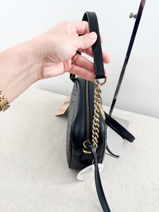 Gucci GG marmont camera bag in matelasse chevron leather with antique gold hardware and chain strap detailing
