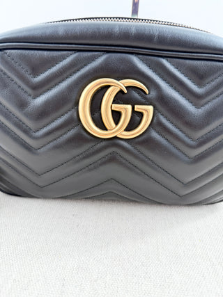 Gucci GG marmont camera bag in matelasse chevron leather with antique gold hardware and chain strap detailing