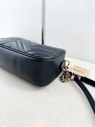Gucci GG marmont camera bag in matelasse chevron leather with antique gold hardware and chain strap detailing
