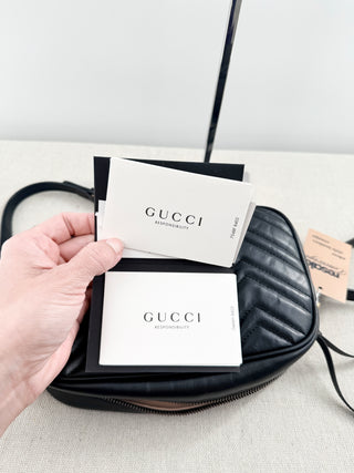Gucci GG marmont camera bag in matelasse chevron leather with antique gold hardware and chain strap detailing