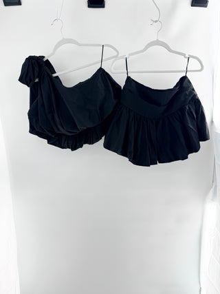 More To Come two-piece set featuring asymmetrical one-shoulder top with oversized bow accent and coordinating high-rise skirt with gathered ruffle detailing in lightweight fabric, S