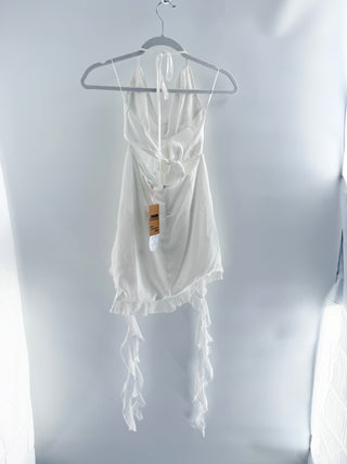 More To Come mini dress featuring plunging halter neckline, dramatic waist cutouts, and rosette detailing at center front, designed with flowy asymmetrical hem, S