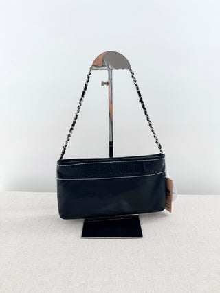CHANEL vintage leather chain shoulder bag featuring embossed tonal CHANEL logo across front with contrast stitching and leather-threaded chain straps