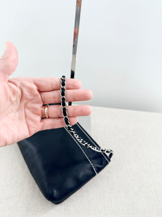 CHANEL vintage leather chain shoulder bag featuring embossed tonal CHANEL logo across front with contrast stitching and leather-threaded chain straps