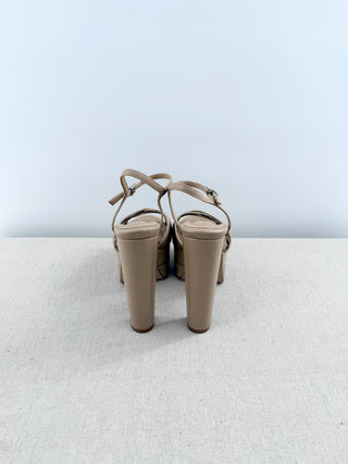Schutz Keefa platform sandals in leather featuring padded crisscross front straps, adjustable slingback strap, chunky block heel, 6
