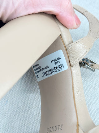 Schutz Keefa platform sandals in leather featuring padded crisscross front straps, adjustable slingback strap, chunky block heel, 6