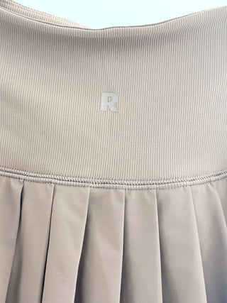 recess pickleball cropped long-sleeve polo top featuring classic collar, partial button placket and matching high-rise pleated tennis skirt with built-in shorts, XS