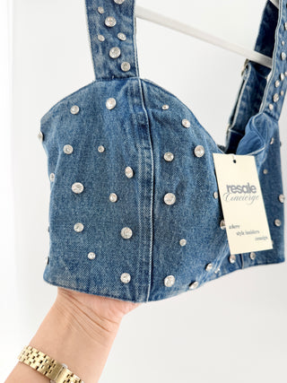 Show Me Your Mumu two-piece denim set featuring rhinestone structured cropped bustier top and matching high-waisted mini skirt embellished with sparkling crystal details throughout and rhinestone western belt, S