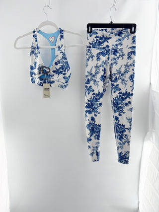 love shack fancy x beach riot activewear set featuring floral toile-print sports bra with cutout detail and signature heart-shaped hardware at center and coordinating high-waisted leggings, XS