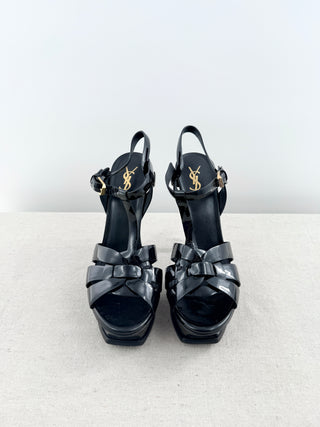 YSL Tribute sandals crafted in glossy patent leather featuring iconic interwoven front straps, adjustable ankle straps, and stiletto heel, 40.5