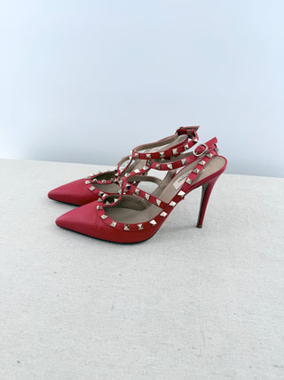 Valentino Rockstud pumps crafted in grained calfskin leather featuring pointed toe, adjustable slingback straps, and platinum-finish signature rockstud embellishments, 41