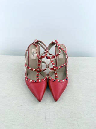 Valentino Rockstud pumps crafted in grained calfskin leather featuring pointed toe, adjustable slingback straps, and platinum-finish signature rockstud embellishments, 41