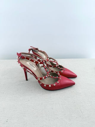 Valentino Rockstud pumps crafted in grained calfskin leather featuring pointed toe, adjustable slingback straps, and platinum-finish signature rockstud embellishments, 41