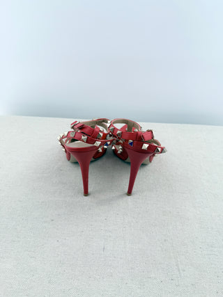 Valentino Rockstud pumps crafted in grained calfskin leather featuring pointed toe, adjustable slingback straps, and platinum-finish signature rockstud embellishments, 41