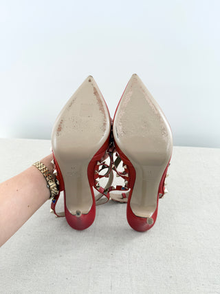 Valentino Rockstud pumps crafted in grained calfskin leather featuring pointed toe, adjustable slingback straps, and platinum-finish signature rockstud embellishments, 41