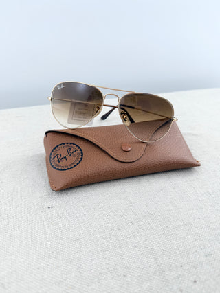 Ray Ban Aviator sunglasses featuring lightweight frame, and classic teardrop-shaped lenses