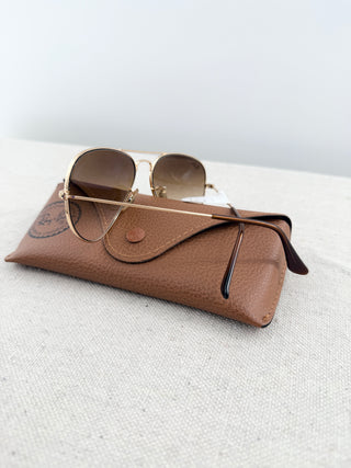Ray Ban Aviator sunglasses featuring lightweight frame, and classic teardrop-shaped lenses