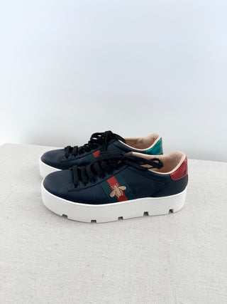 Gucci Ace platform sneakers crafted in smooth leather featuring iconic green and red web stripe with embroidered gold bee detail, finished with chunky platform sole, 38.5
