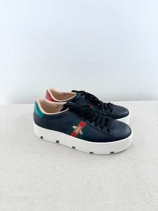 Gucci Ace platform sneakers crafted in smooth leather featuring iconic green and red web stripe with embroidered gold bee detail, finished with chunky platform sole, 38.5