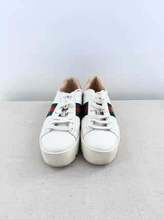 Gucci Ace platform sneakers crafted in smooth leather with iconic green and red web stripe and embroidered gold bee detail, finished with metallic heel tabs, and chunky platform rubber sole, 38.5