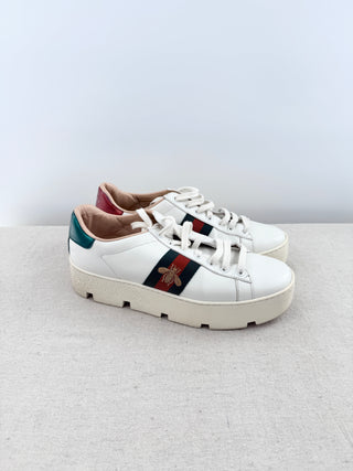 Gucci Ace platform sneakers crafted in smooth leather with iconic green and red web stripe and embroidered gold bee detail, finished with metallic heel tabs, and chunky platform rubber sole, 38.5