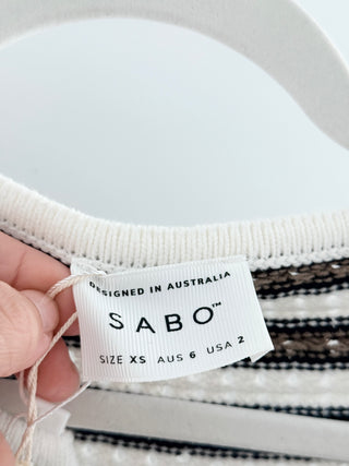 Sabo Kaeli knit mini dress designed with rounded neckline, full-length sleeves, and button-front closure with fabric-covered buttons crafted from textured cotton-blend knit, XS