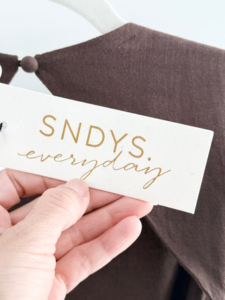 Sndys maxi dress featuring high neckline, flattering smocked waist, open-back detail, and flowing tiered skirt, S