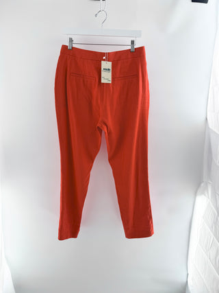 Rag and Bone tailored cropped trousers crafted in lightweight linen-blend fabric, features mid-rise waist, tapered leg, front slash pockets with button-tab accents, 4