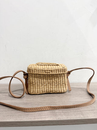 Nannacay small straw bag with pom pom charms and long strap