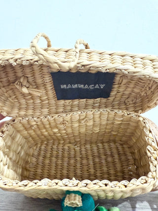 Nannacay small straw bag with pom pom charms and long strap