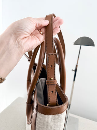 Balmain logo tote bag crafted from jacquard canvas featuring signature tonal monogram pattern, accented with smooth cognac leather trim, dual rolled top handles and detachable shoulder strap