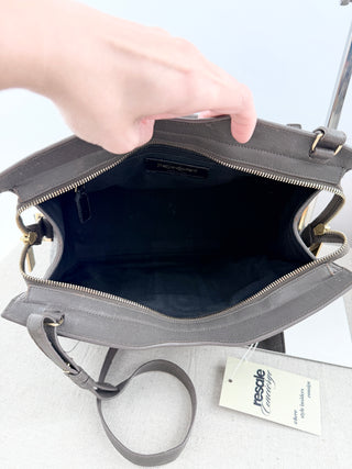 YSL cabas chyc leather tote featuring iconic gold-tone Y hardware, dual rolled top handles, expandable side gussets