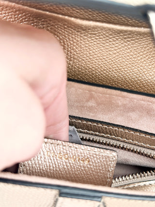 Christian Dior saddle bag crafted in grained calfskin leather featuring asymmetrical saddle silhouette, front flap closure, and oversized antique "D" charm