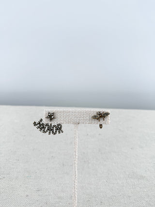 Christian Dior mismatched earring pair featuring sparkling crystal-encrusted J'Adior logo suspended from a star stud with a coordinating crystal bee stud
