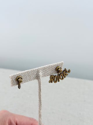 Christian Dior mismatched earring pair featuring sparkling crystal-encrusted J'Adior logo suspended from a star stud with a coordinating crystal bee stud