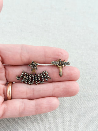 Christian Dior mismatched earring pair featuring sparkling crystal-encrusted J'Adior logo suspended from a star stud with a coordinating crystal bee stud