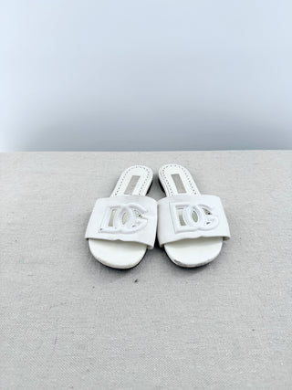 Dolce and Gabbana leather slide sandals featuring signature cutout DG logo across the vamp, 32