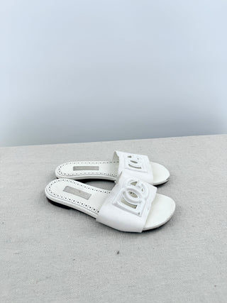 Dolce and Gabbana leather slide sandals featuring signature cutout DG logo across the vamp, 32