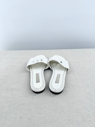 Dolce and Gabbana leather slide sandals featuring signature cutout DG logo across the vamp, 32