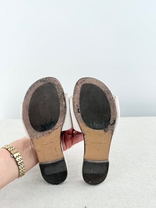 Dolce and Gabbana leather slide sandals featuring signature cutout DG logo across the vamp, 32
