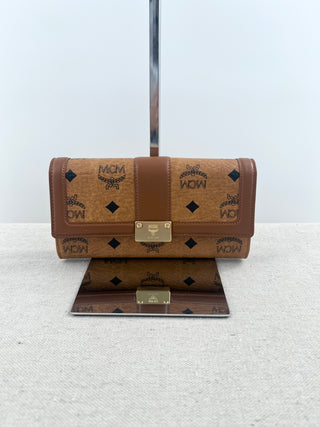 MCM long wallet crafted in iconic cognac visetos coated canvas with logo print and smooth leather accents