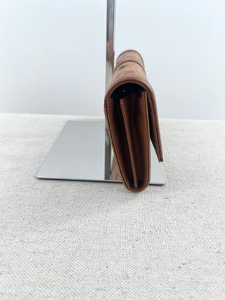 MCM long wallet crafted in iconic cognac visetos coated canvas with logo print and smooth leather accents