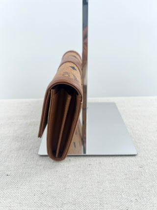 MCM long wallet crafted in iconic cognac visetos coated canvas with logo print and smooth leather accents