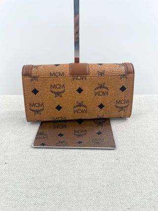 MCM long wallet crafted in iconic cognac visetos coated canvas with logo print and smooth leather accents